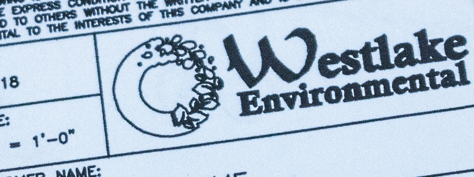 Close up of Westlake Environmental Engineering print, focused on Westlake Environmental logo on name plate, with blue wash